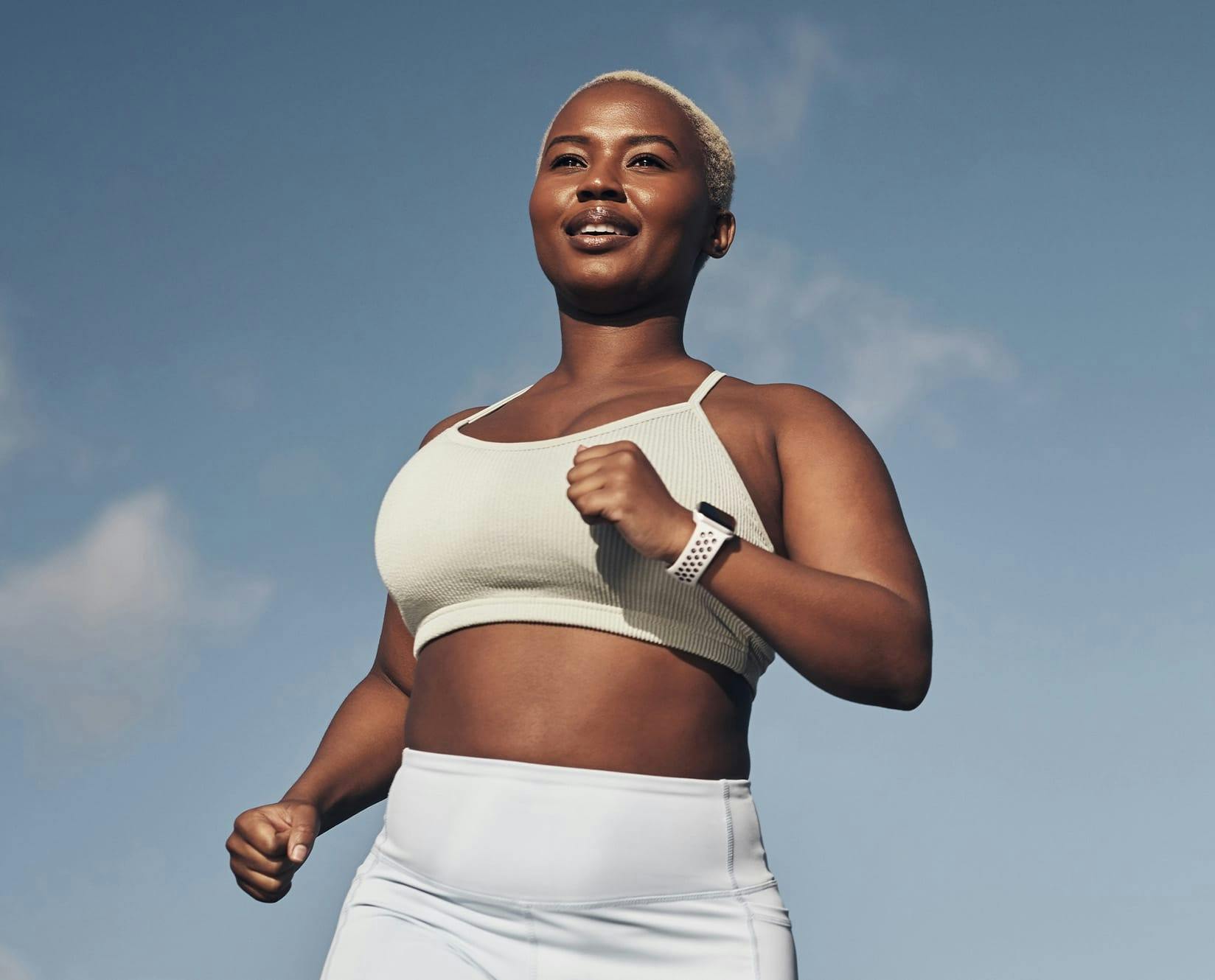 woman running in white athletic wear