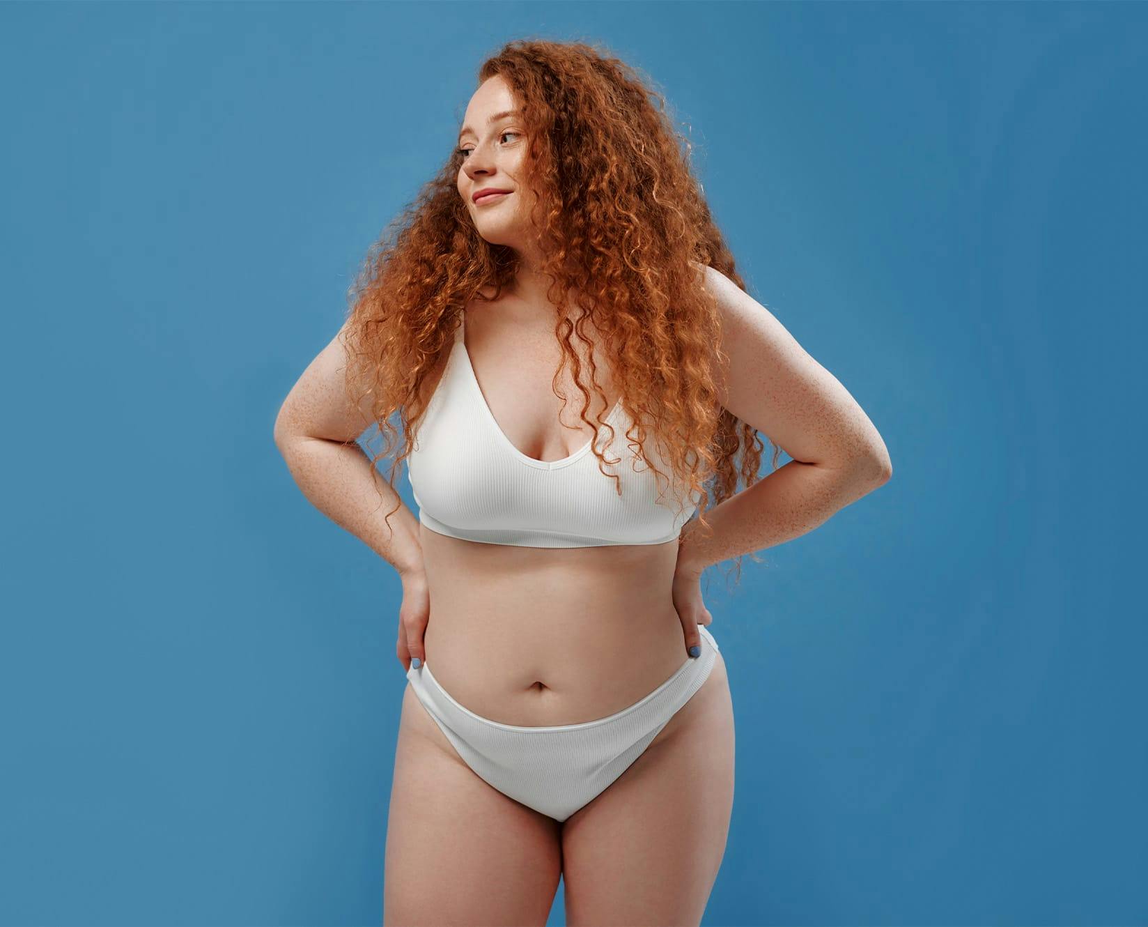 woman with white underwear with curly red hair