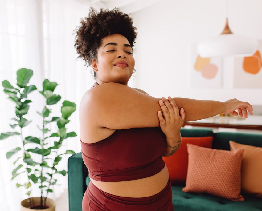 woman stretching her arm to the side