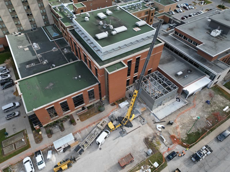 crane building onto the side of a hospital