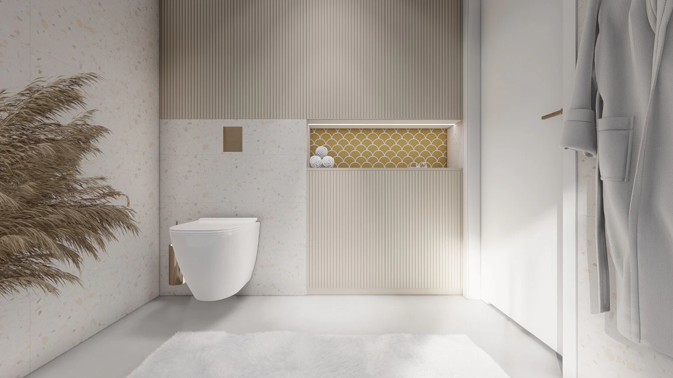 Zabudowa podtynkowa wc z białą misą. i złotych przyciskiem do spłukiwania. Reszta ściany zabudowana meblami na wymiar z ryflowanymi frontami w odcieniu beżu. Szafki podświetlone ledami.