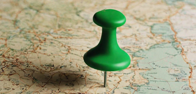 Prompt: A green pushpin in an old-fashioned map