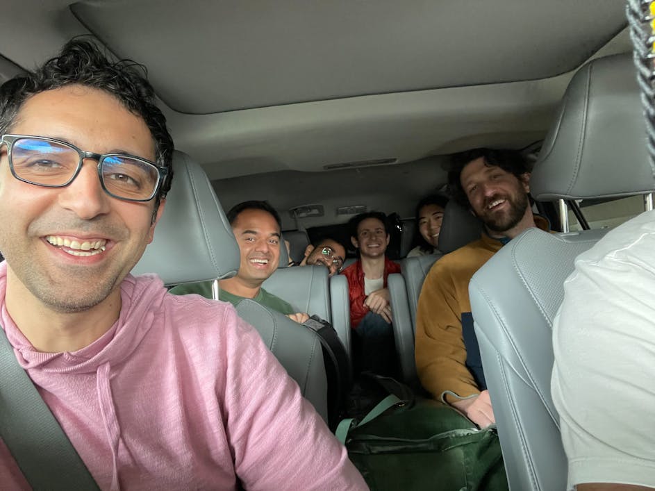 Amir in a car with the team