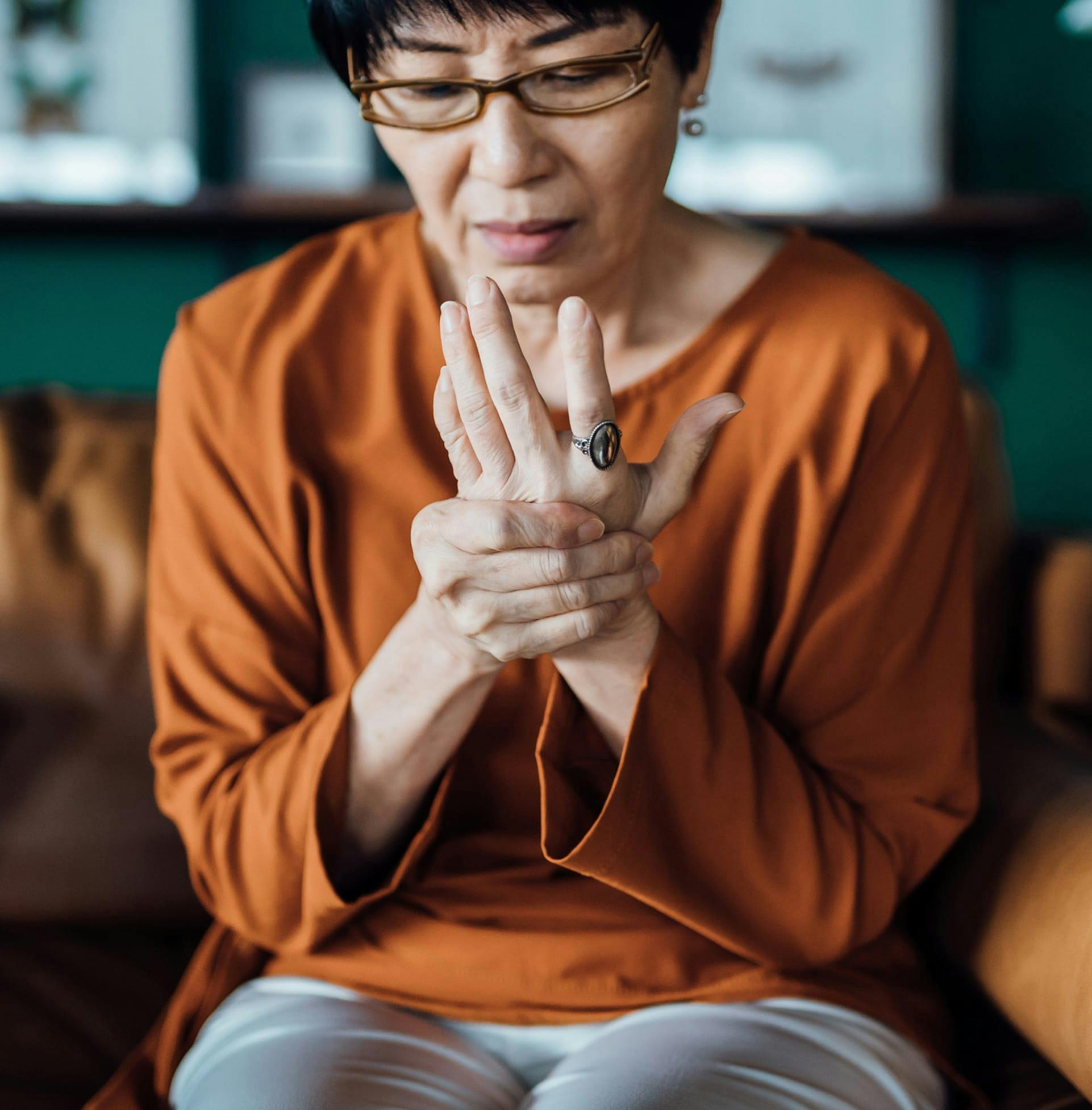 Woman holding hand in pain