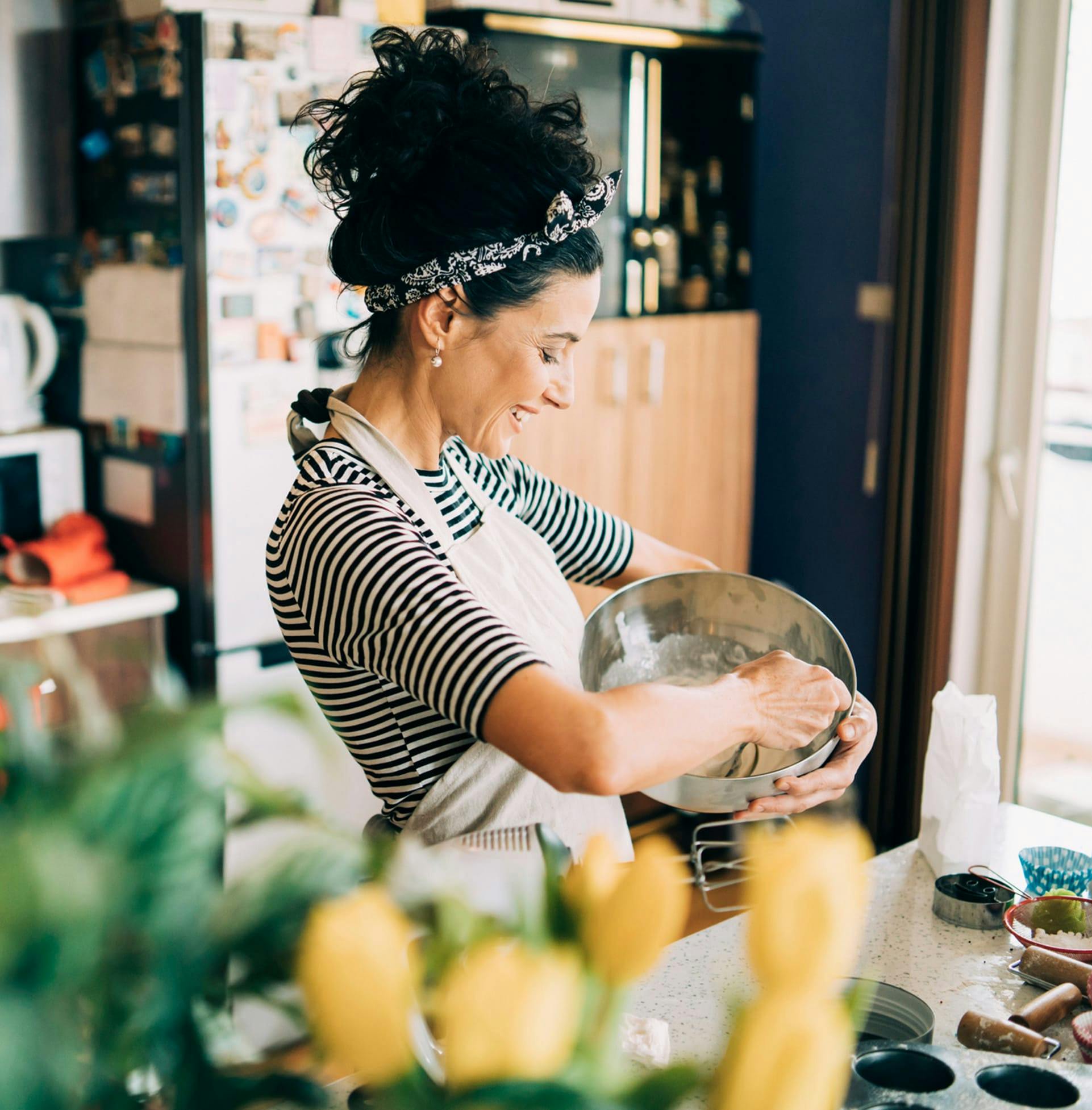 Woman smiling and cooking