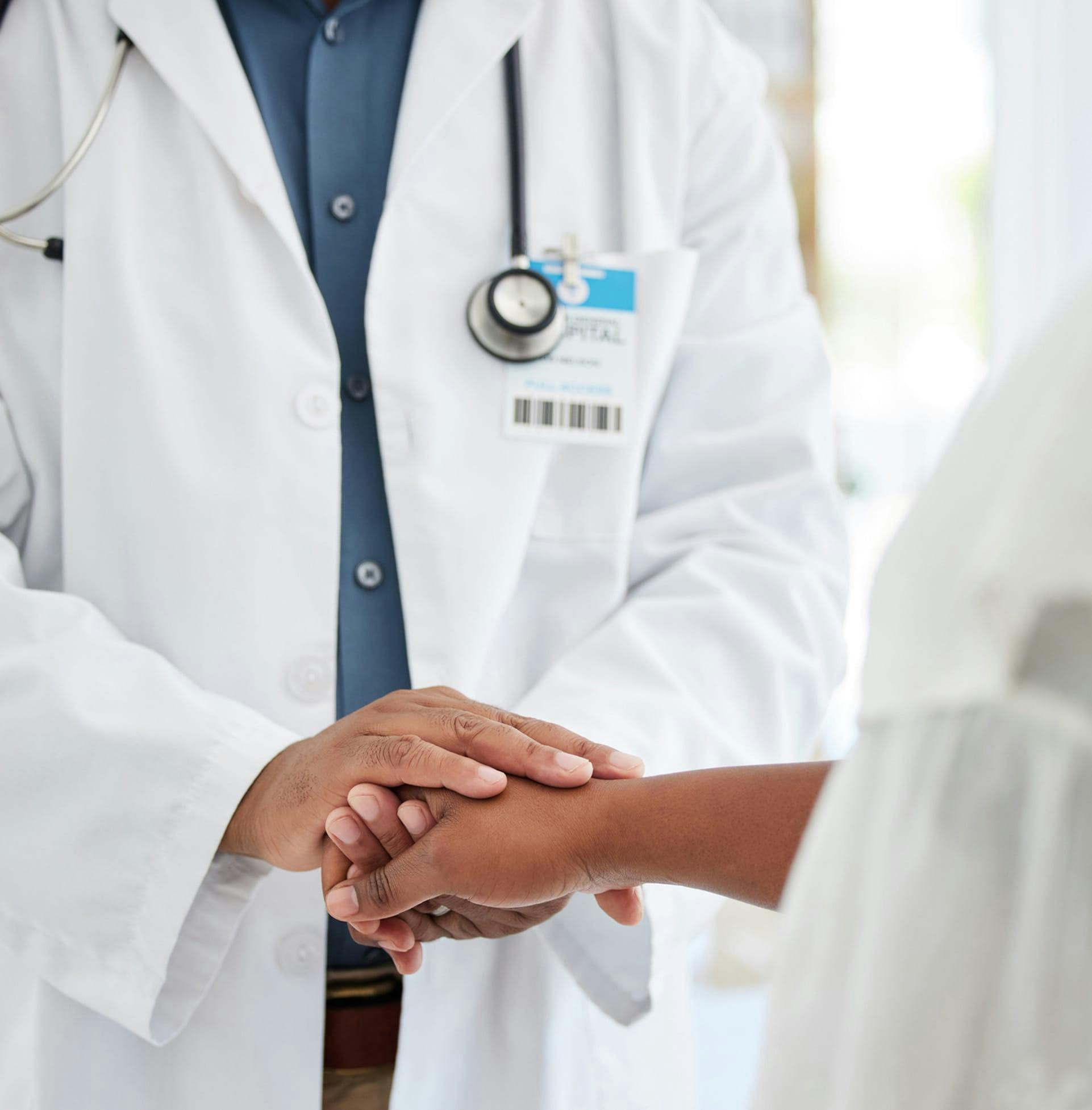 Doctor holding patient's hand