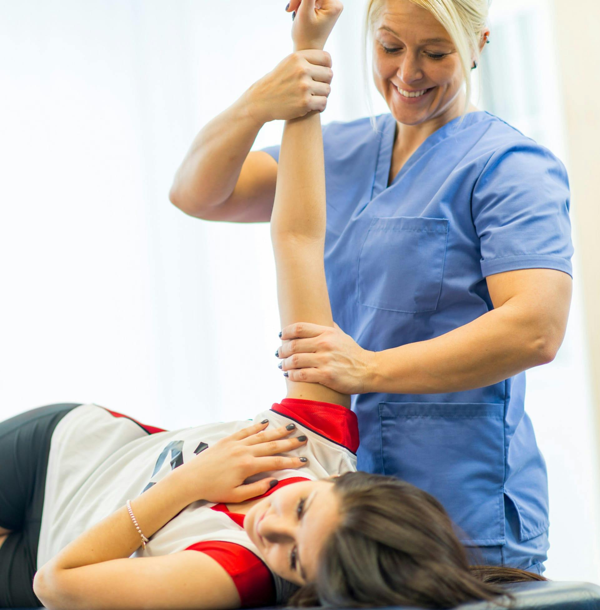 doctor adjusting patient's shoulder