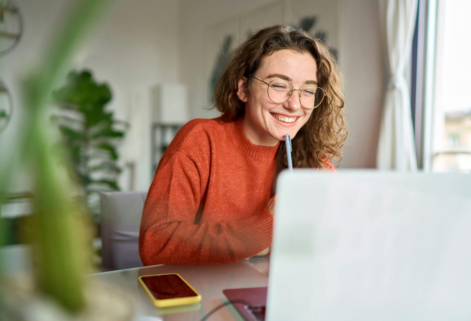 Woman smiling looking at laptop