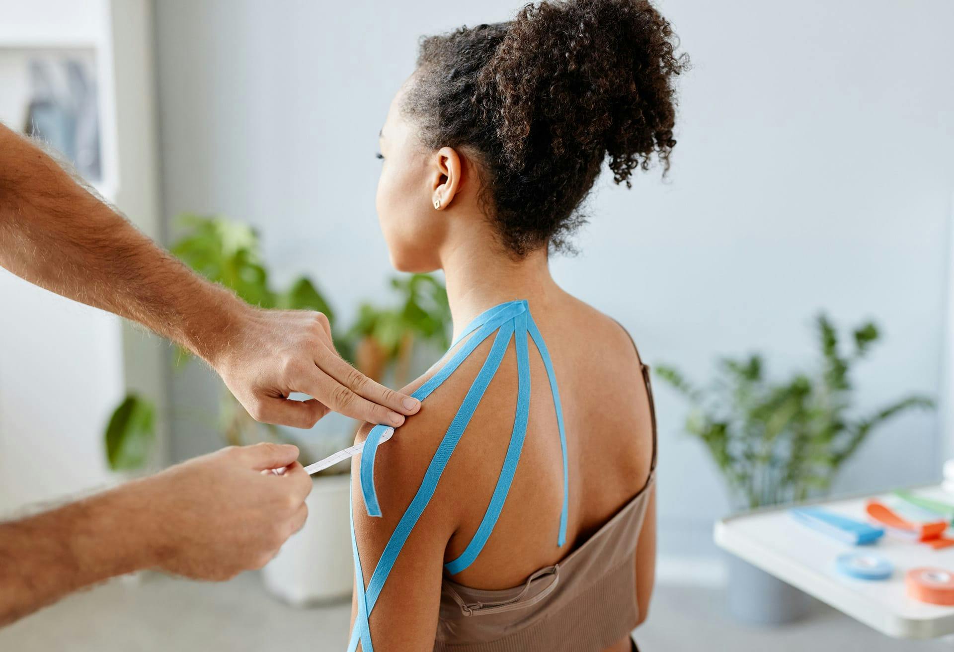 doctor examining patient's shoulder