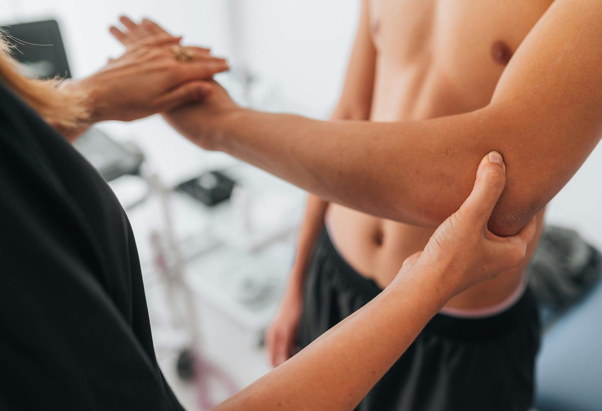 Doctor examining patient's arm