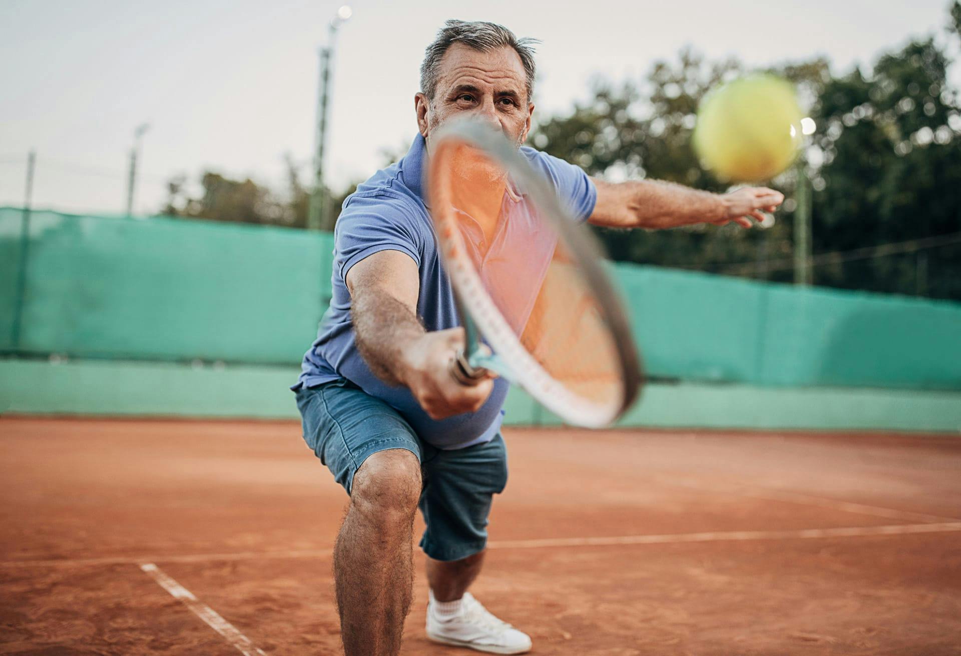 Man about to hit tennis ball with Racket