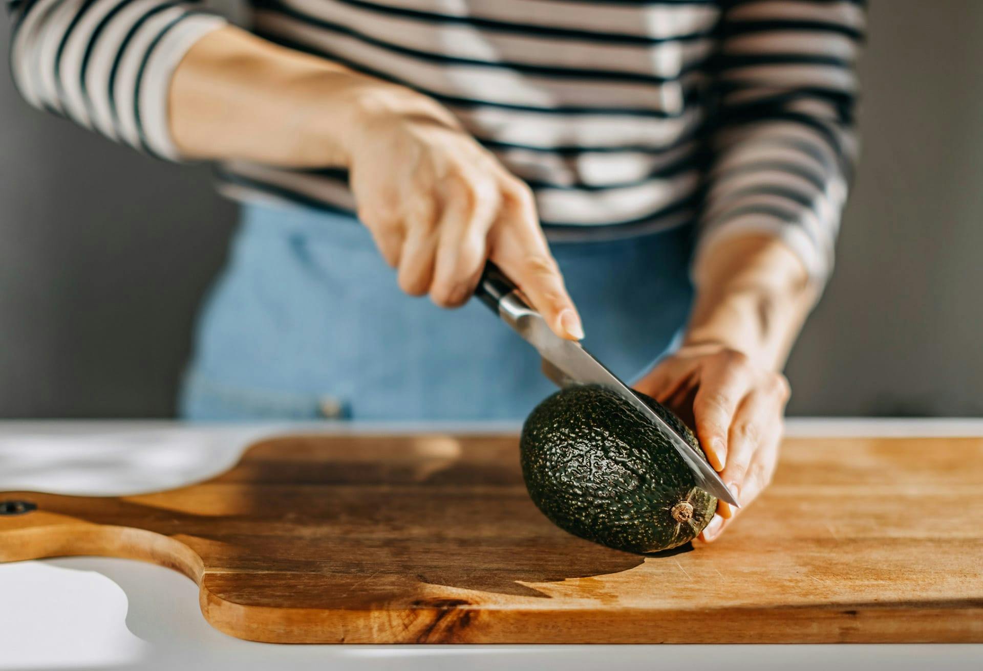 Woman cutting avacado