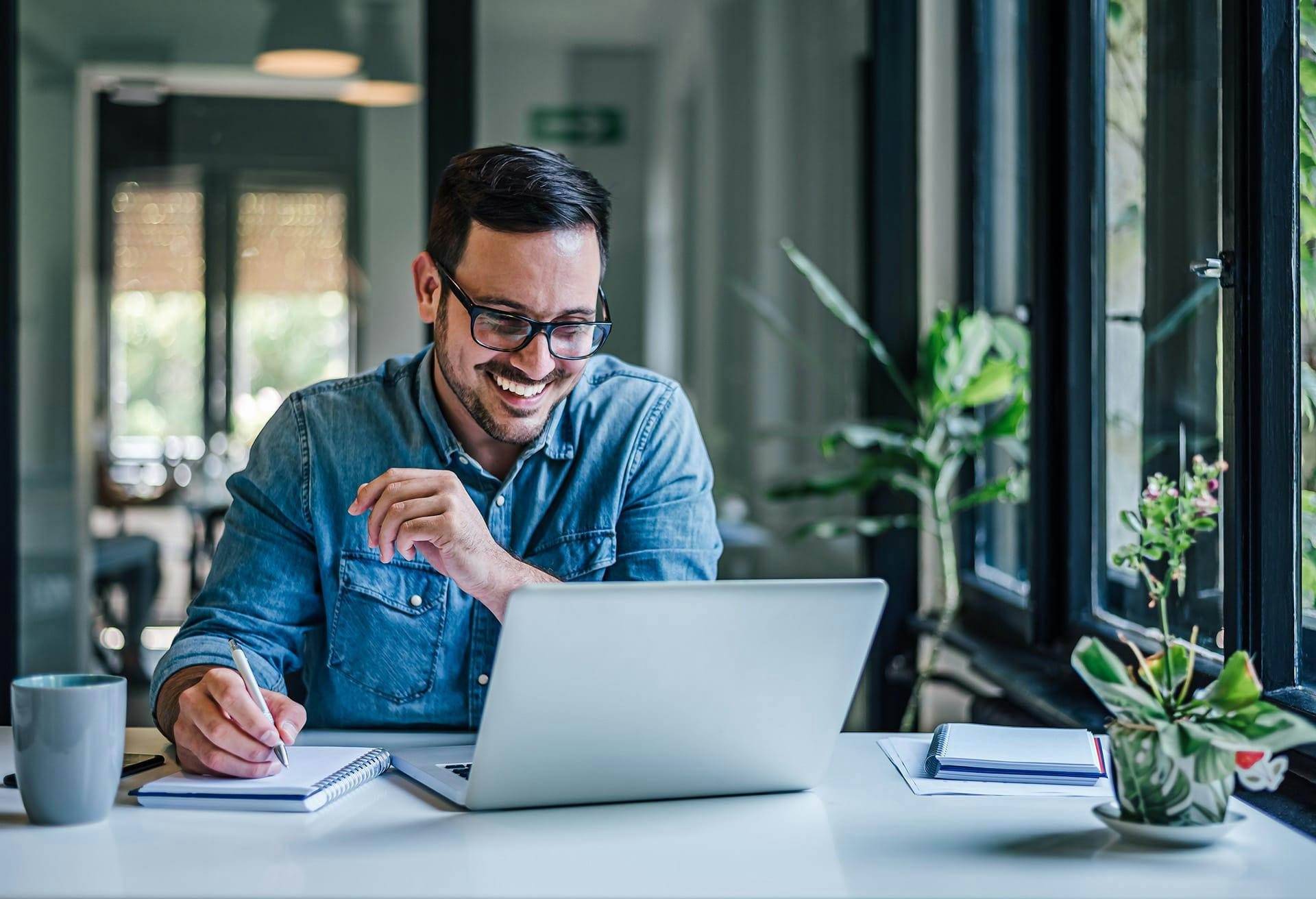 man smiling looking at laptop
