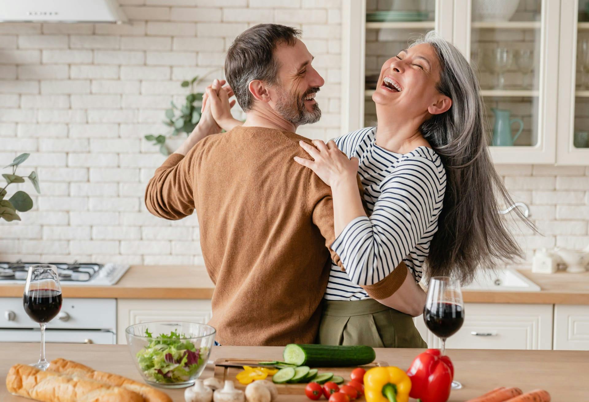 Happy couple dancing in Kitchen