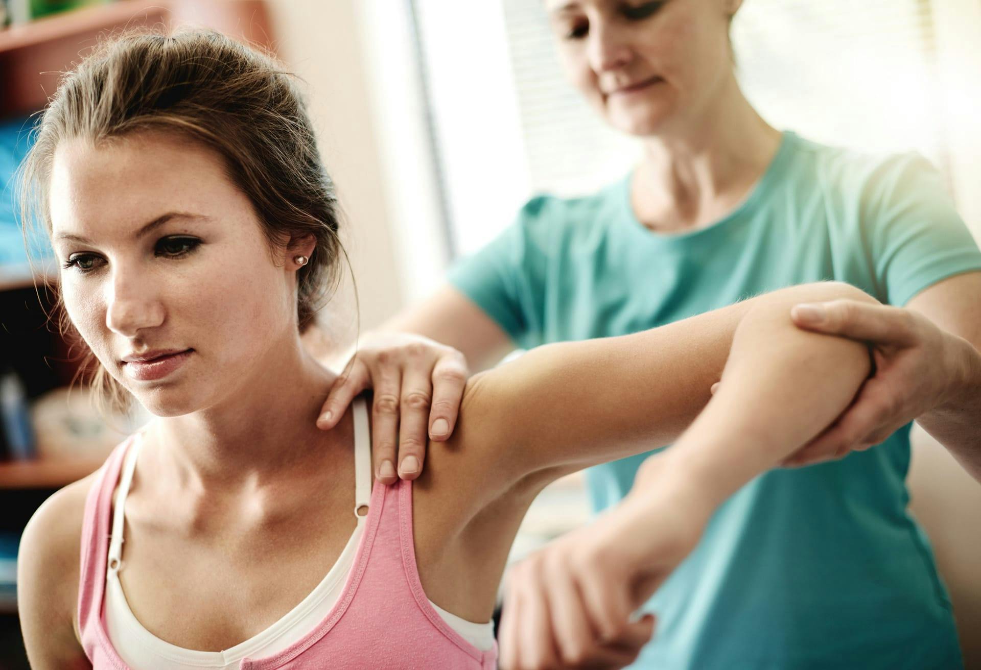 Doctor looking at patient's shoulder