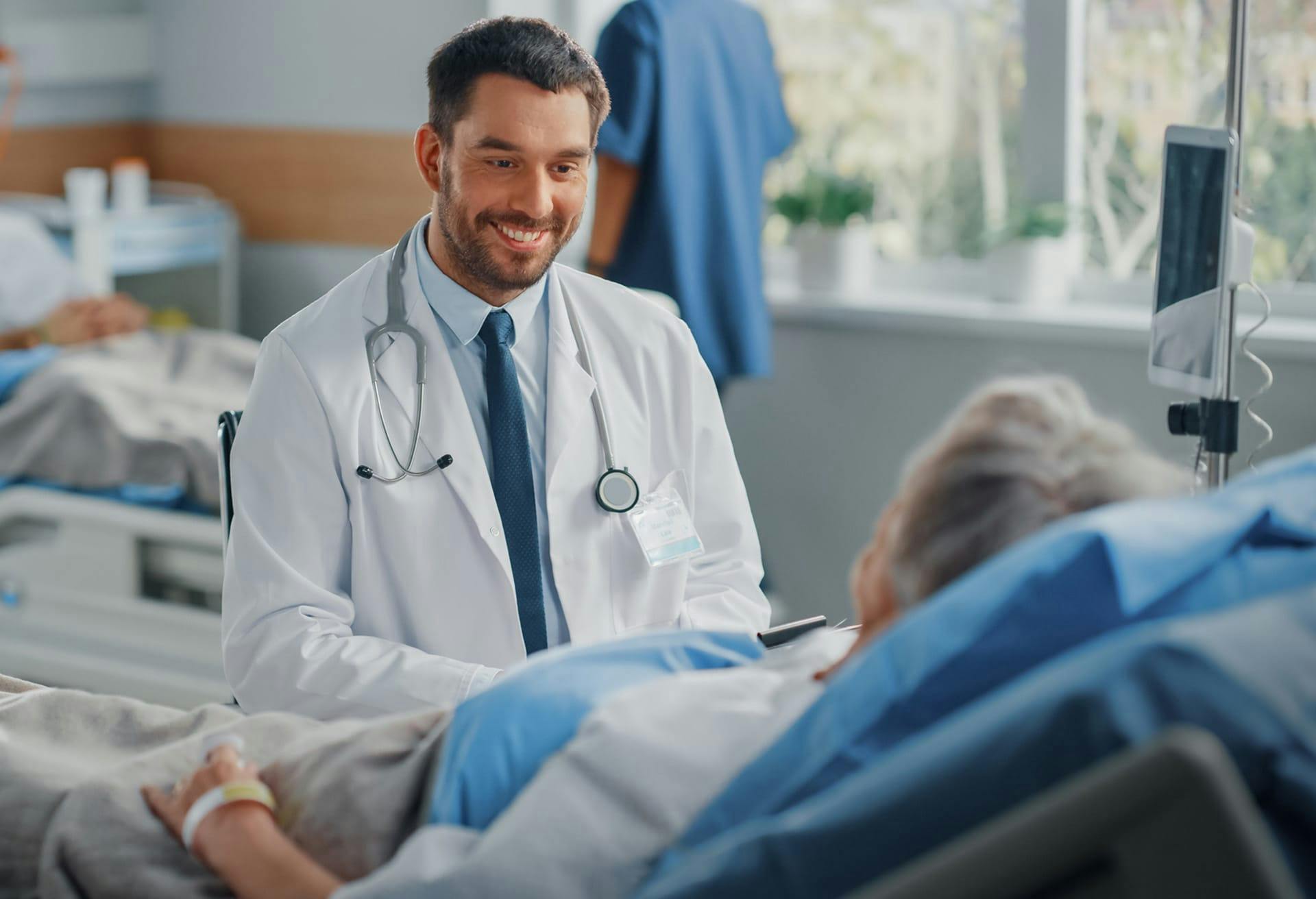 Doctor smiling and speaking with patient
