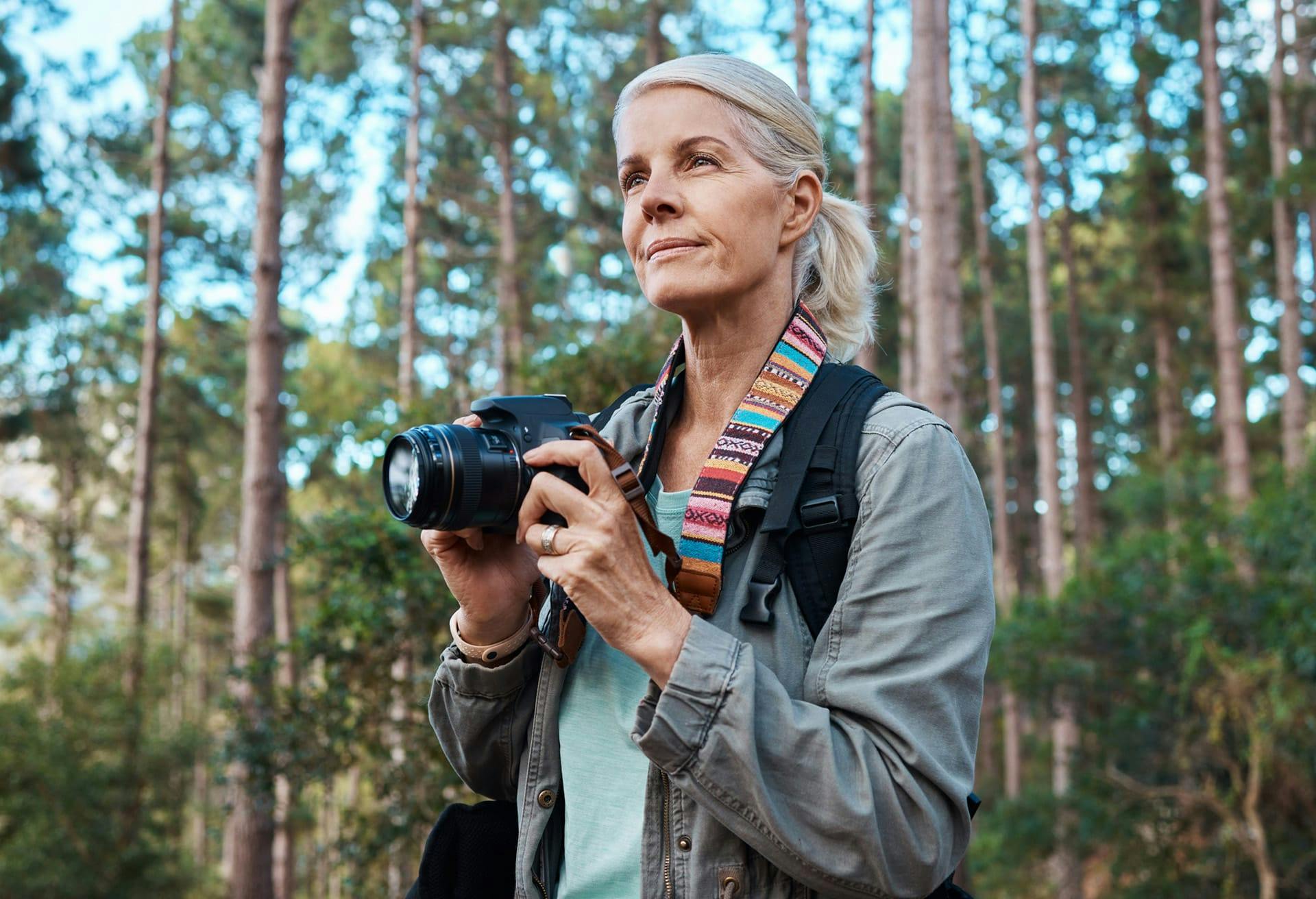 woman with camera in forest
