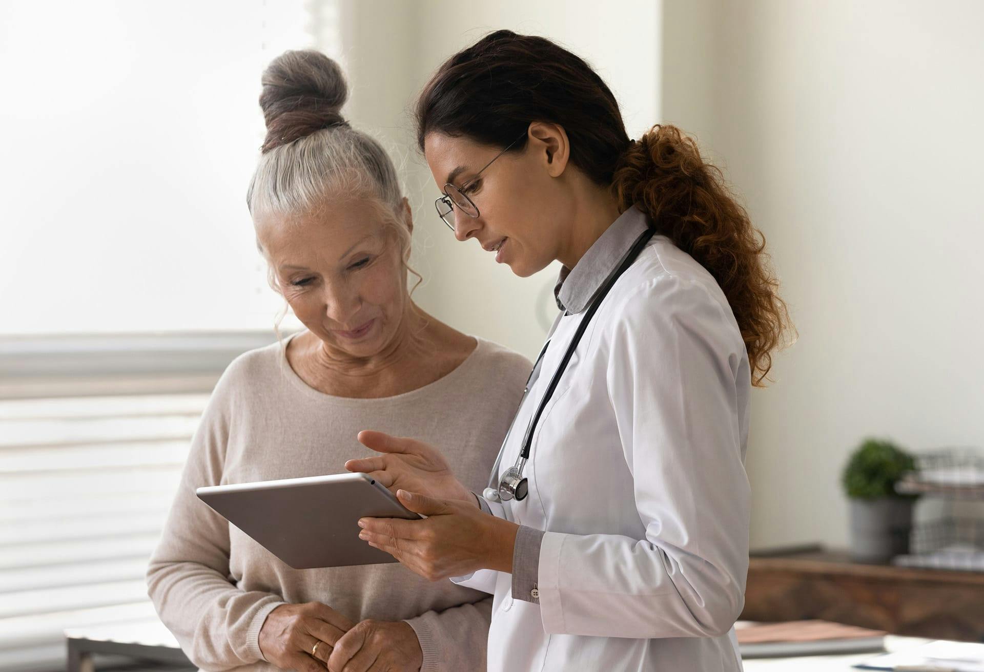 Doctor Showing patient a tablet