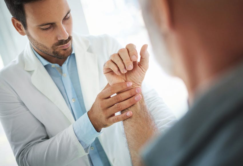 Doctor looking at hand
