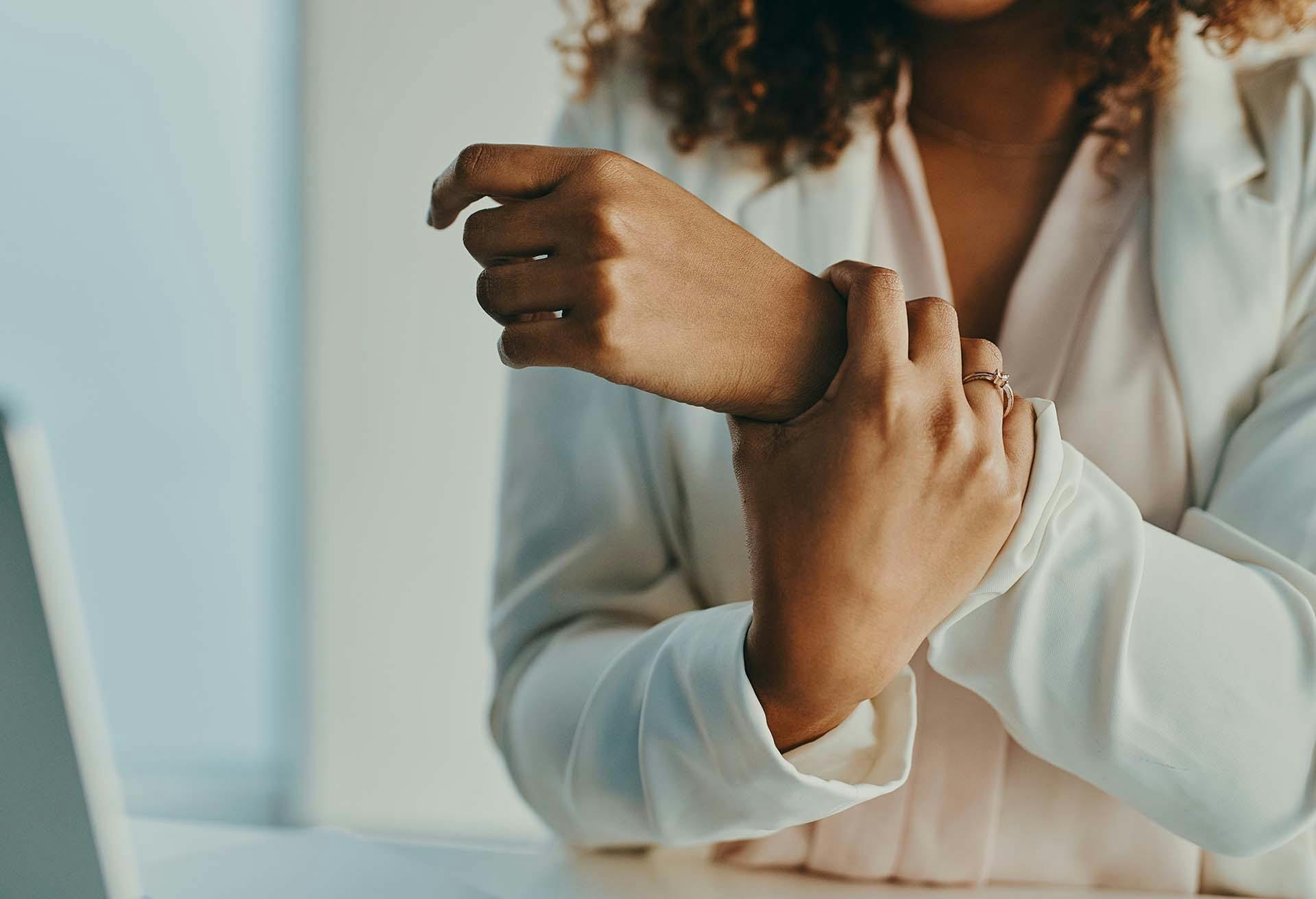 Woman holding wrist in pain