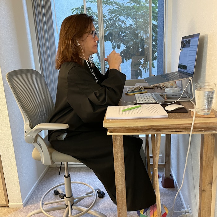 Img: furniture, table, desk, person, sitting, adult, female, woman, laptop, pen