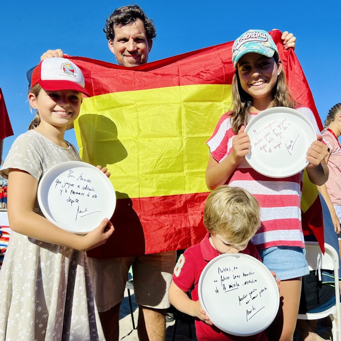 Img: boy, child, male, person, adult, man, hat, chair, plate, flag