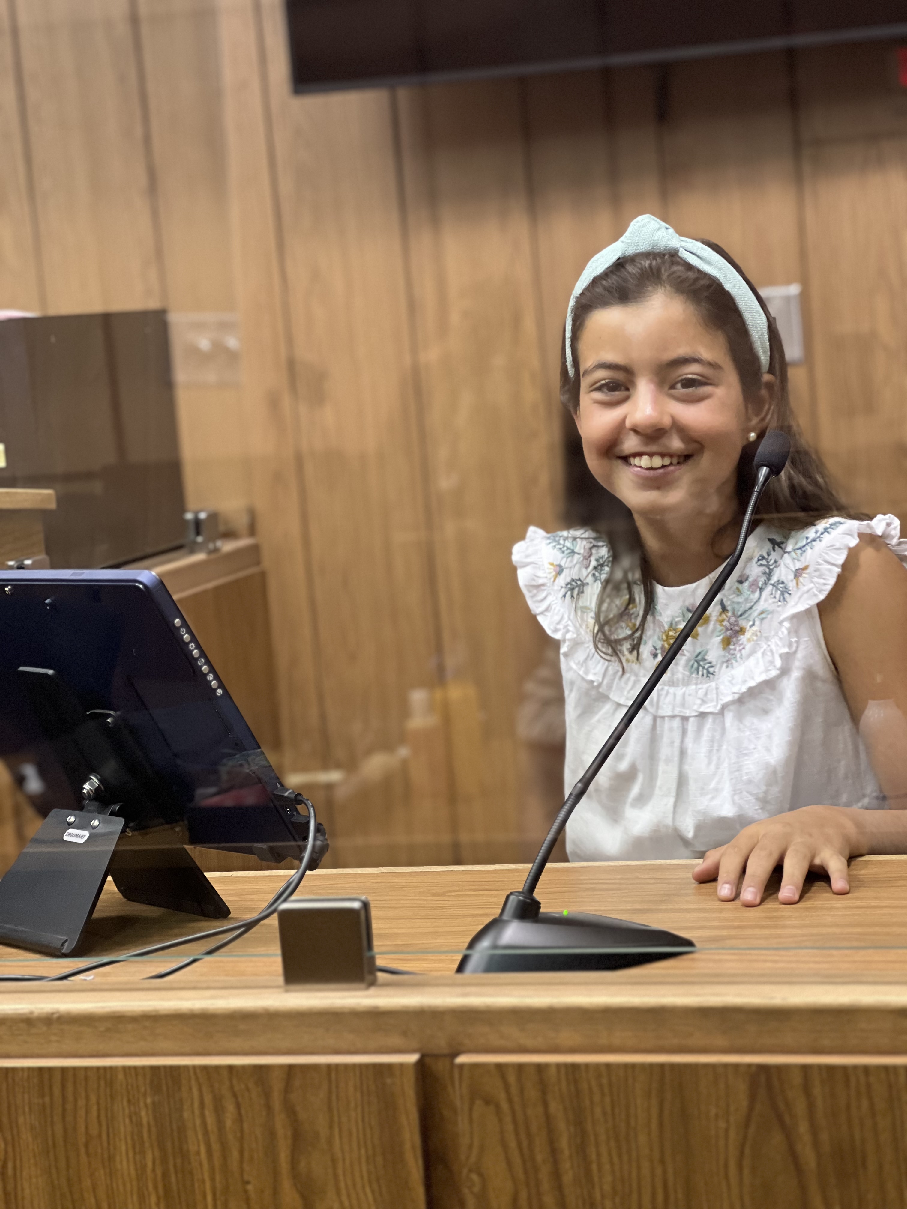 Img: child, female, girl, person, interior design, wood, table, microphone, mobile phone, desk