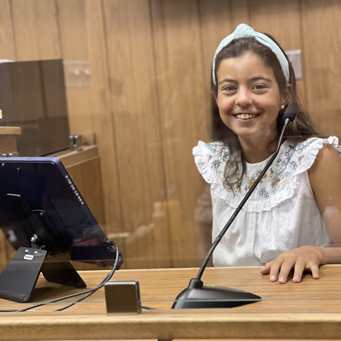 Img: child, female, girl, person, interior design, wood, table, microphone, mobile phone, desk
