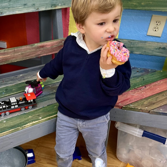 Img: boy, child, male, person, eating, food, footwear, shoe, head, face