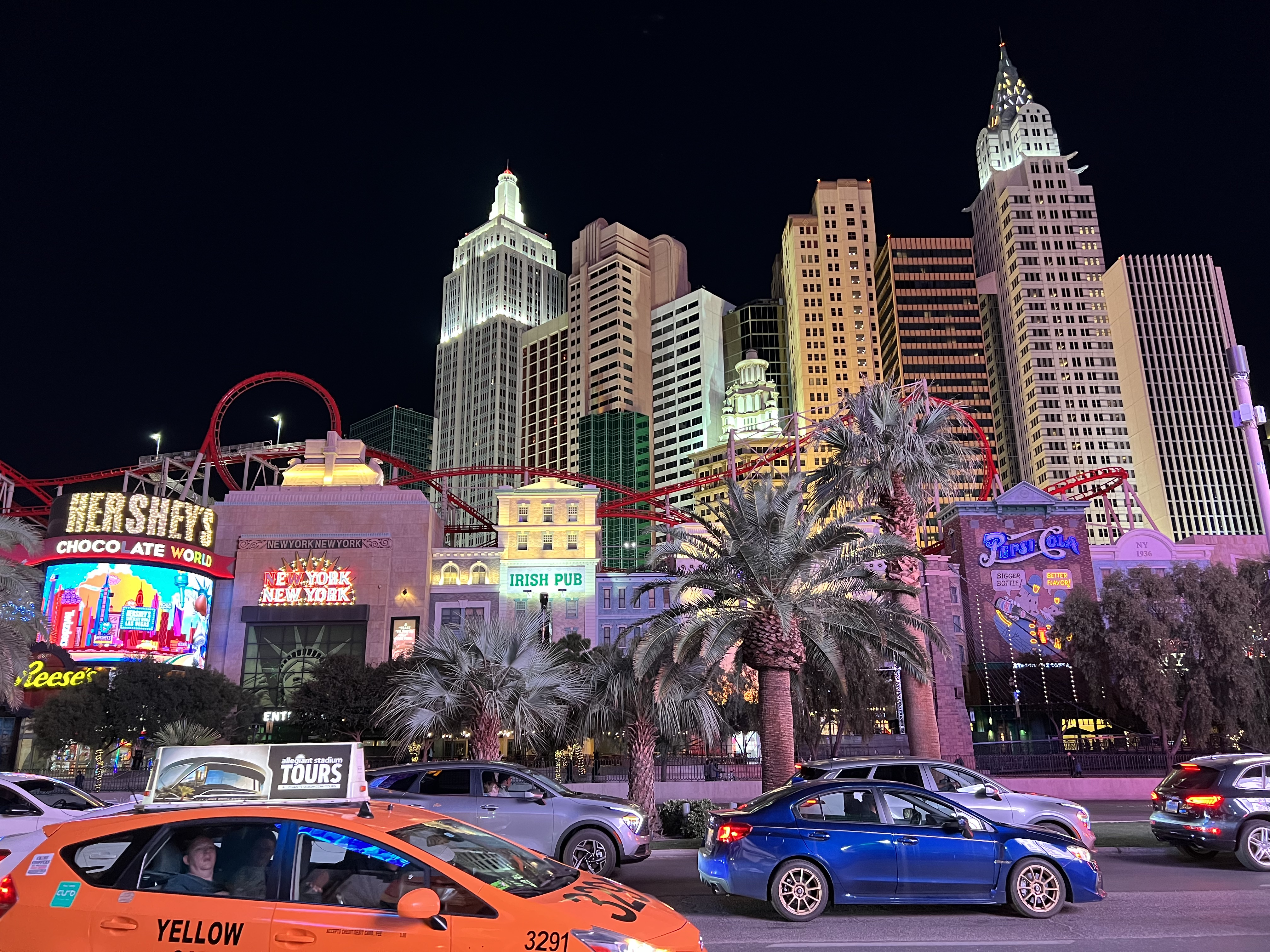 Img: city, metropolis, urban, office building, car, cityscape, person, tree, road, neighborhood