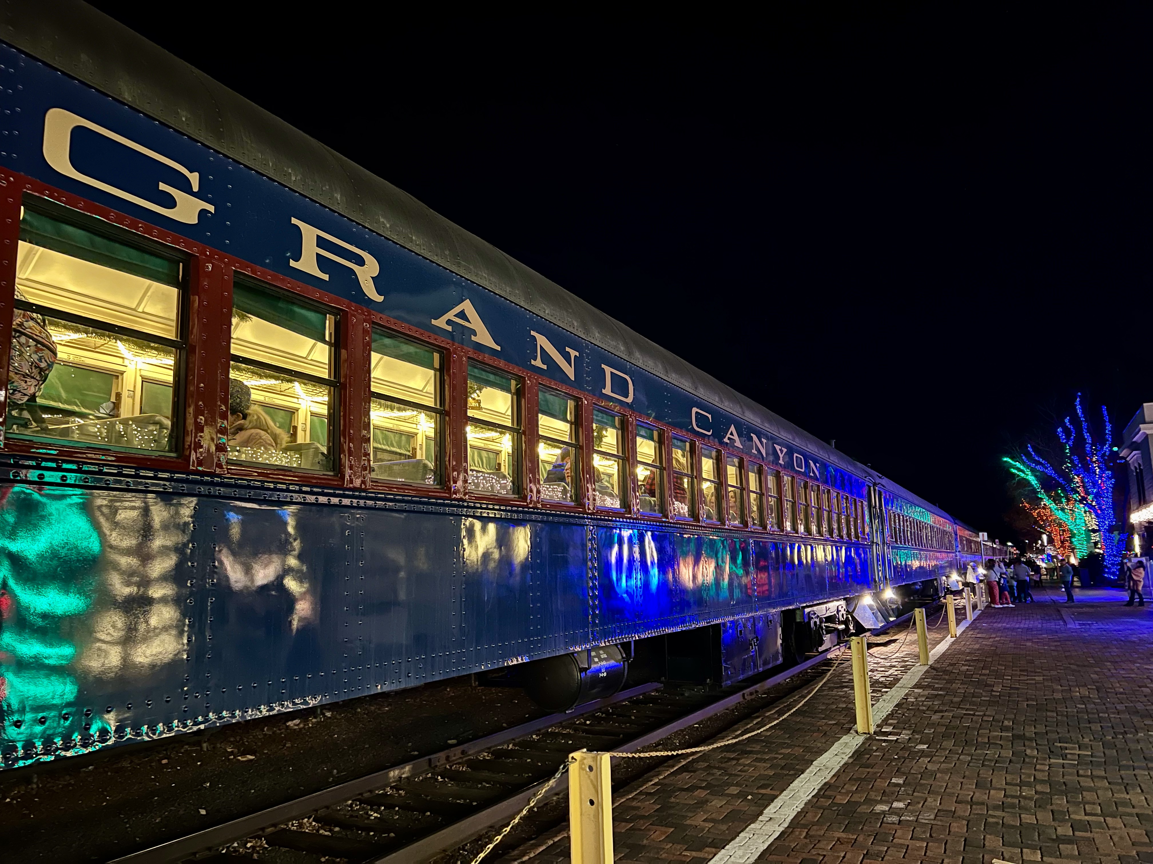 Img: terminal, person, railway, train, train station, transportation, vehicle, clothing, footwear, shoe