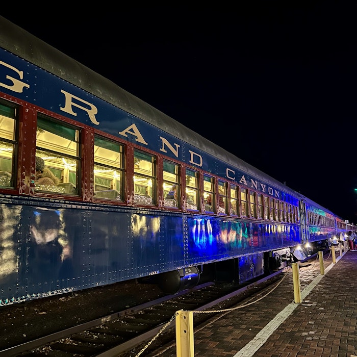 Img: terminal, person, railway, train, train station, transportation, vehicle, clothing, footwear, shoe