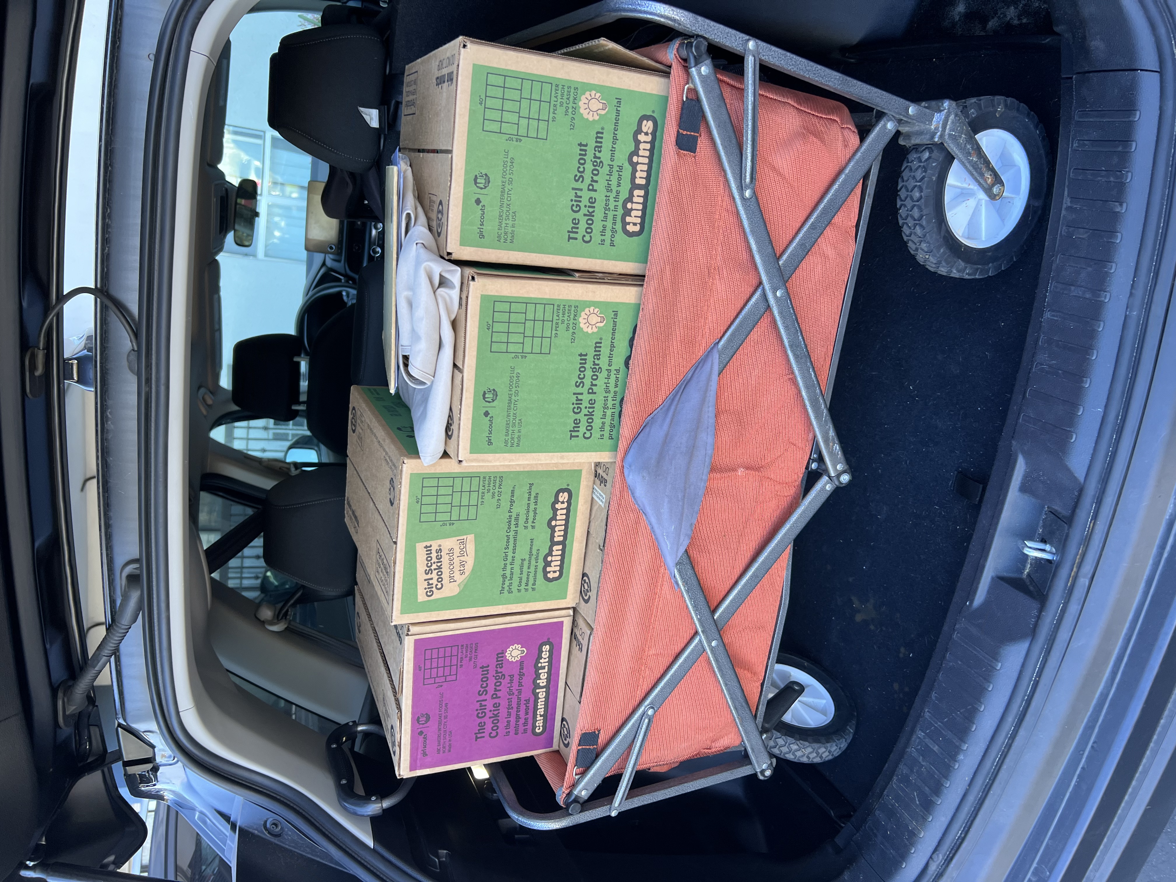 Img: chair, furniture, box, car, transportation, vehicle, car trunk, carton, wheel, package delivery