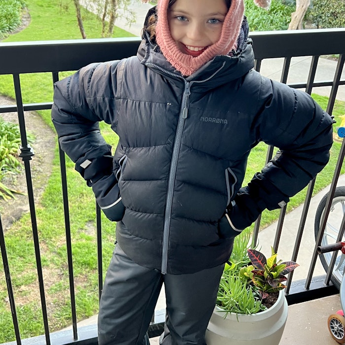 Img: clothing, coat, jacket, person, standing, hood, plant, shoe, hat, cap