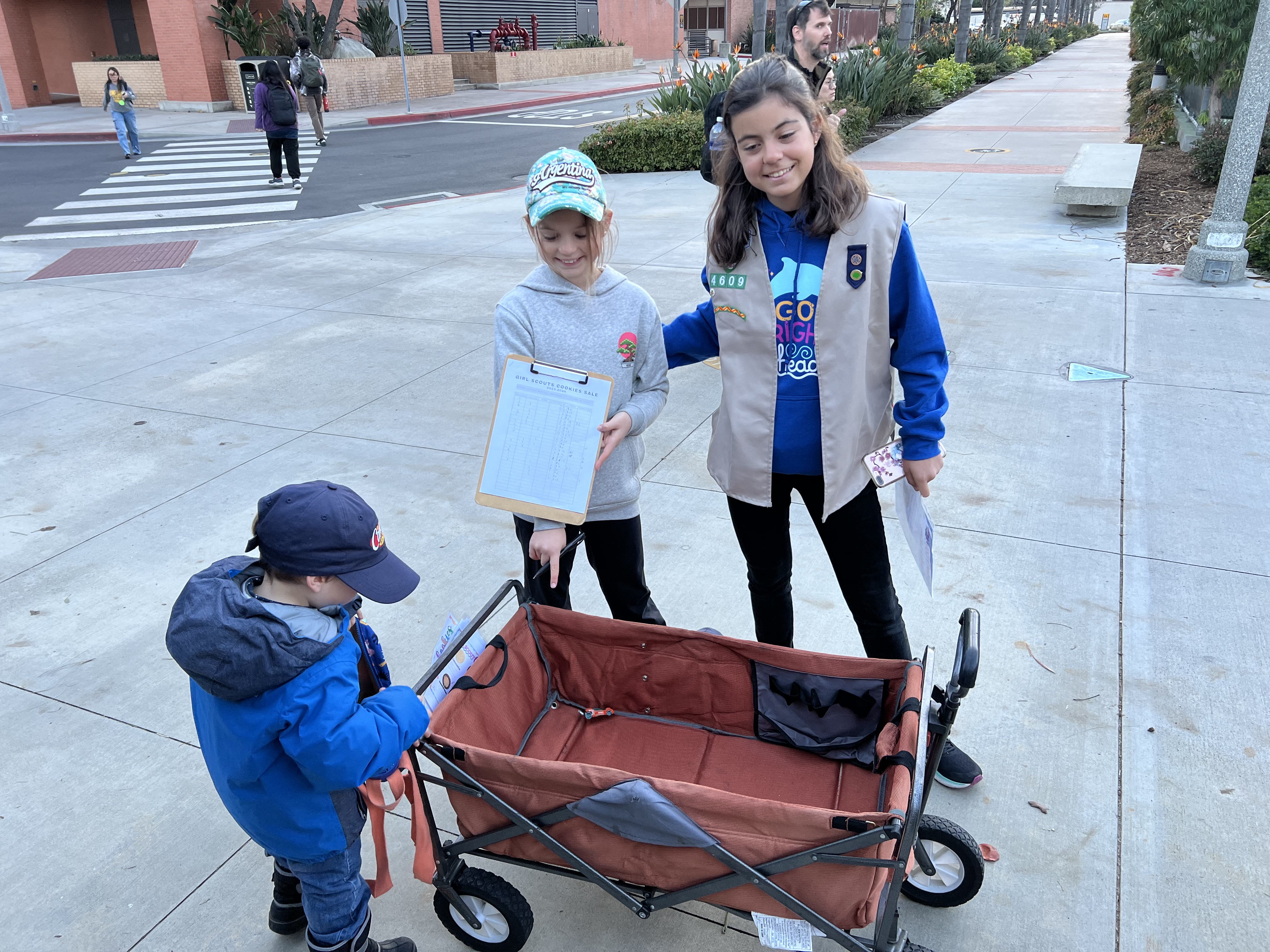 Img: female, girl, person, teen, pants, child, street, hat, boy, male