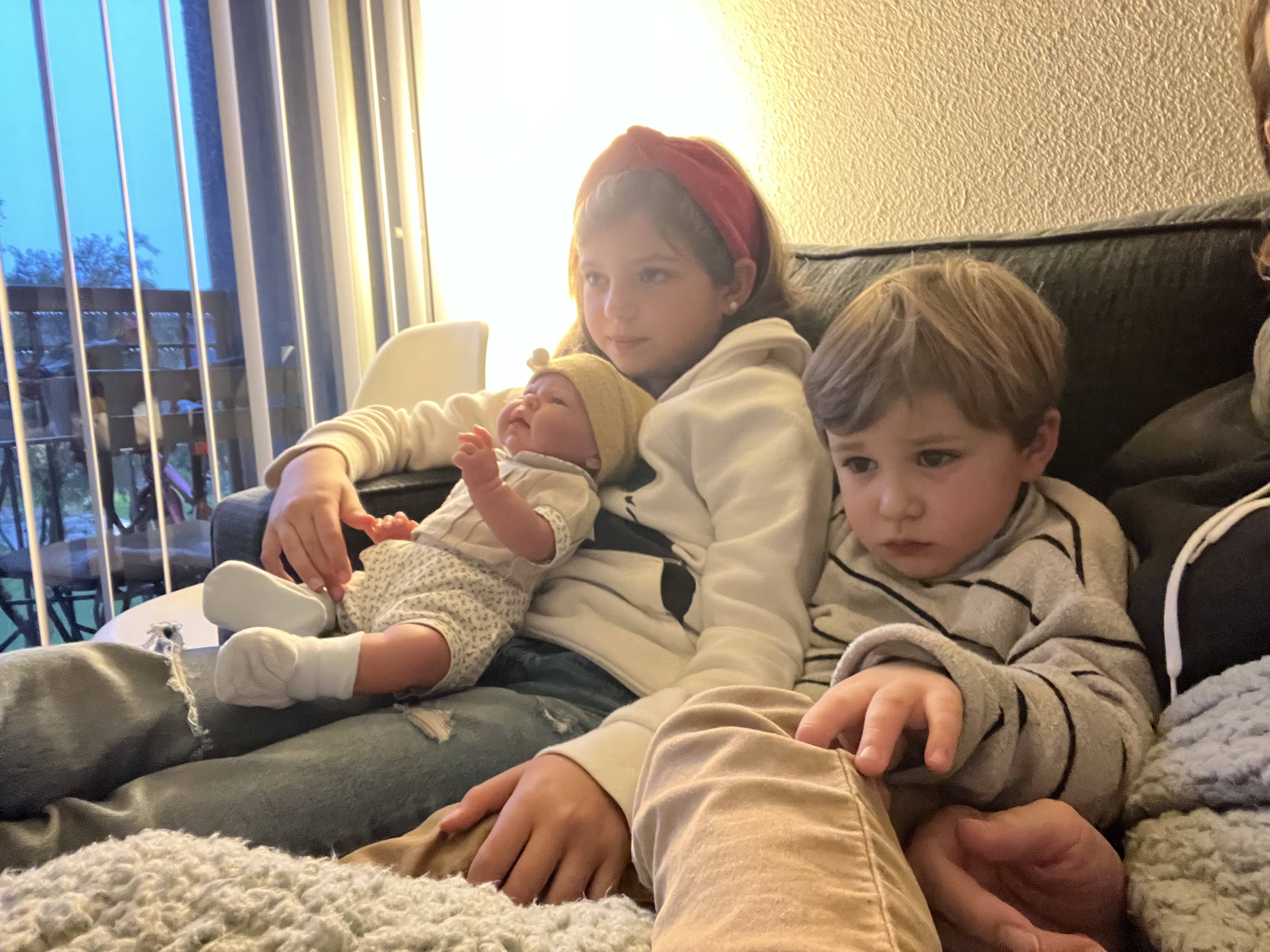 Img: couch, furniture, people, person, baby, finger, hat, cushion, shoe, face