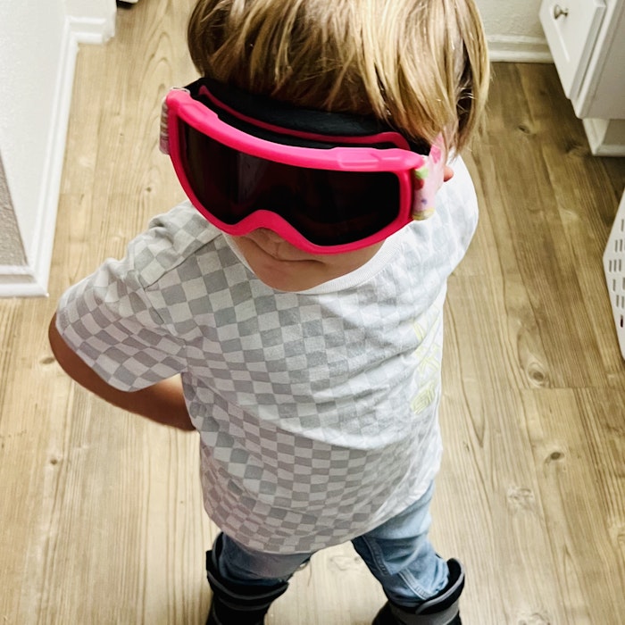 Img: accessories, goggles, sunglasses, person, floor, clothing, pants, footwear, shoe, flooring