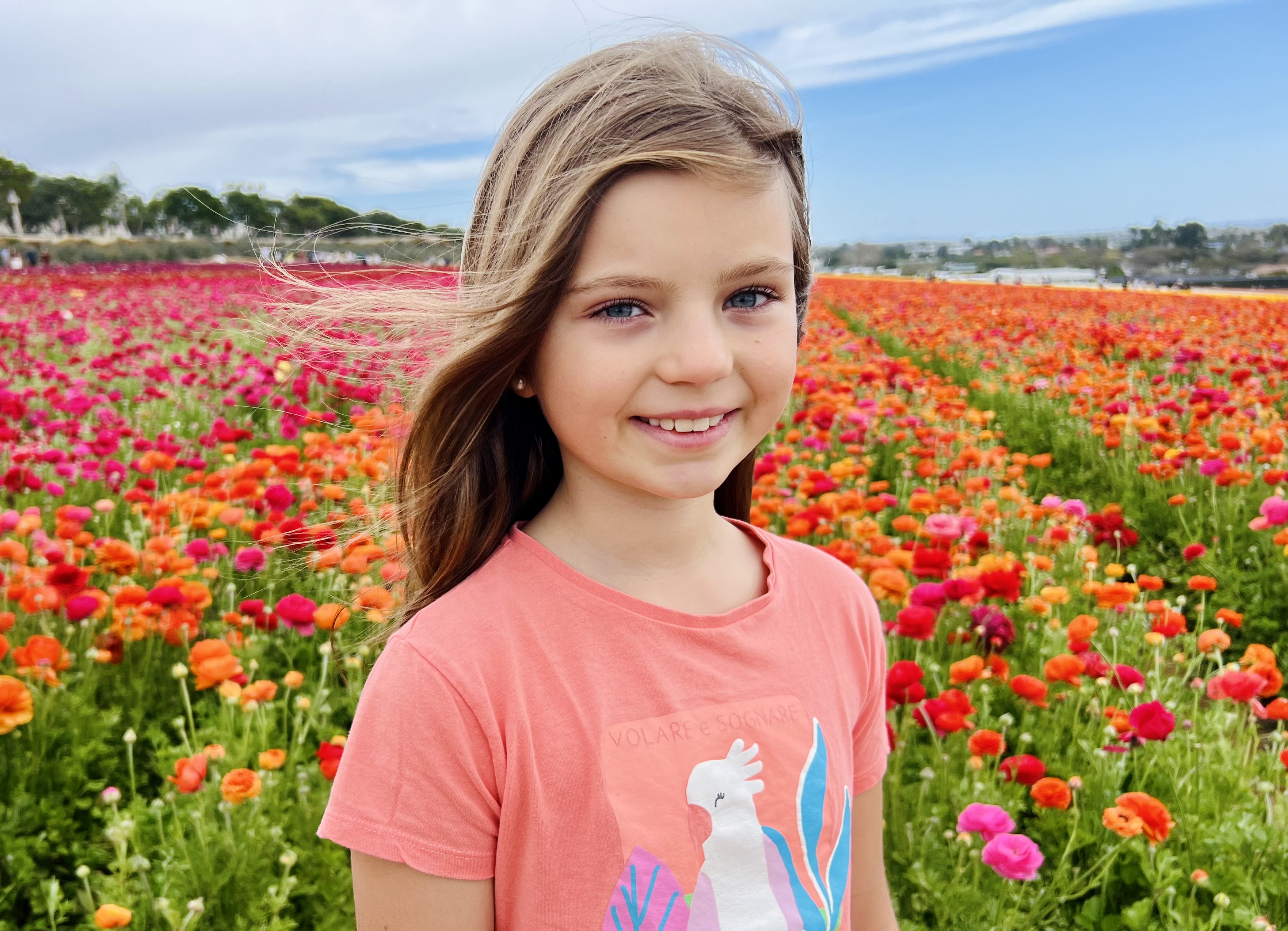 Img: face, head, person, photography, portrait, t-shirt, smile, flower, field, grassland