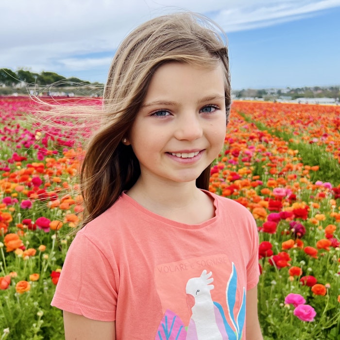 Img: face, head, person, photography, portrait, t-shirt, smile, flower, field, grassland