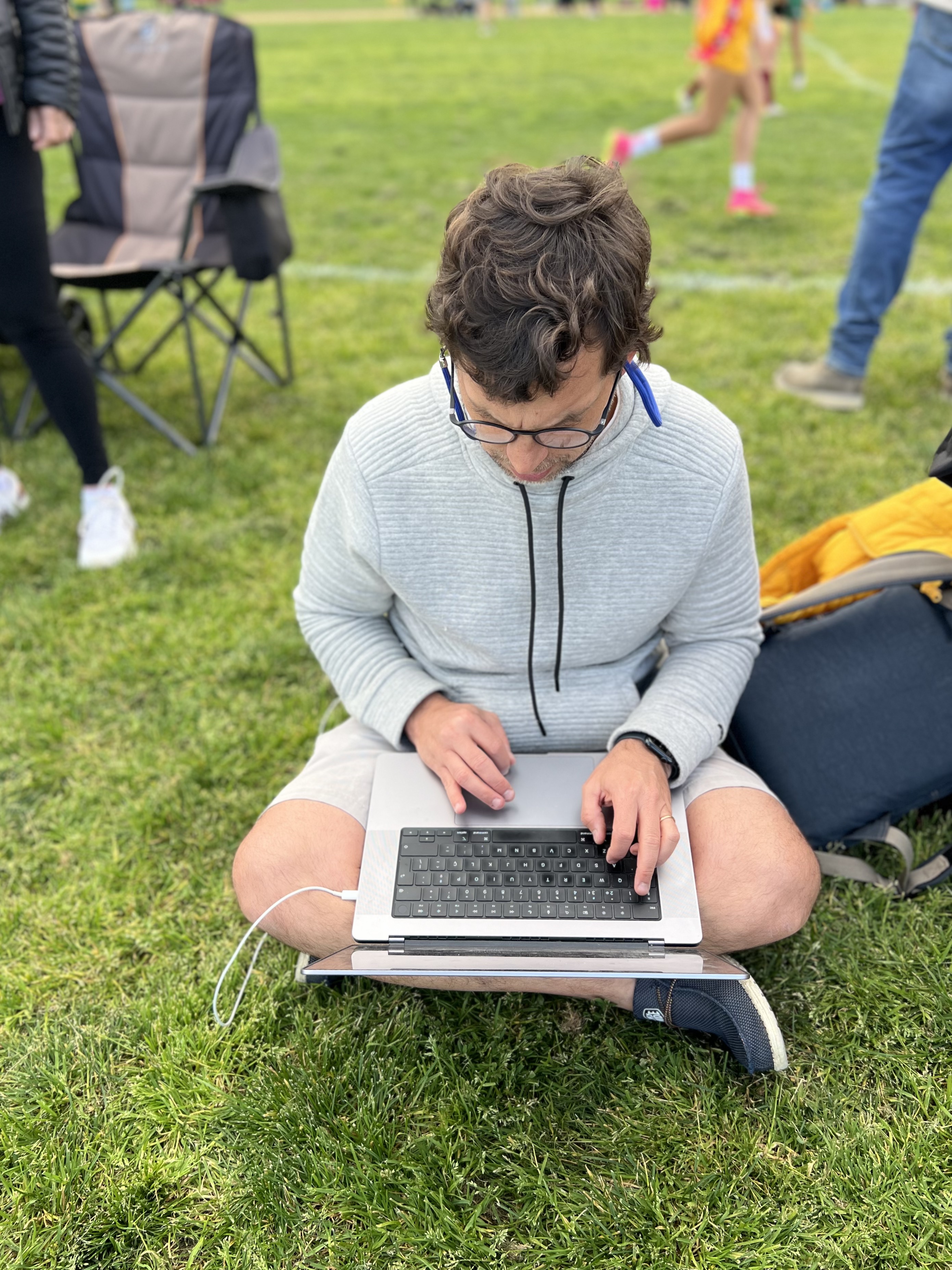 Img: grass, person, sitting, laptop, pc, child, female, girl, jeans, glasses