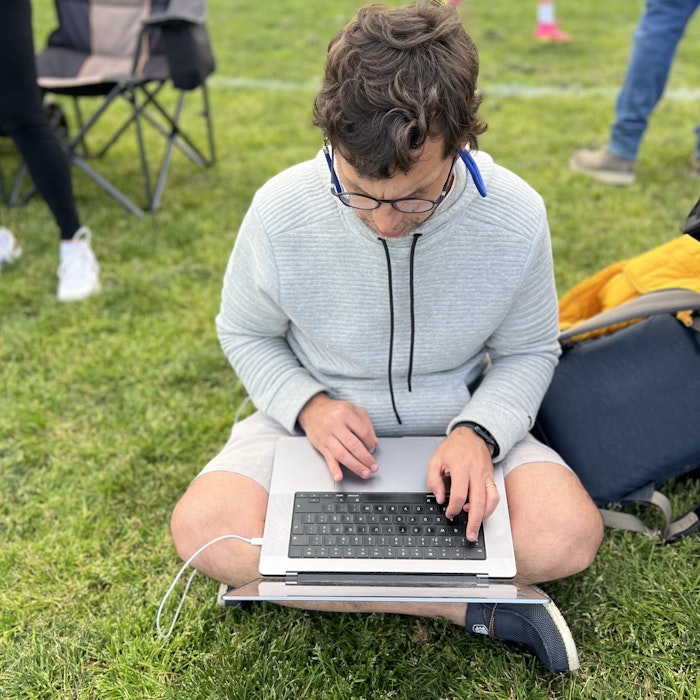 Img: grass, person, sitting, laptop, pc, child, female, girl, jeans, glasses