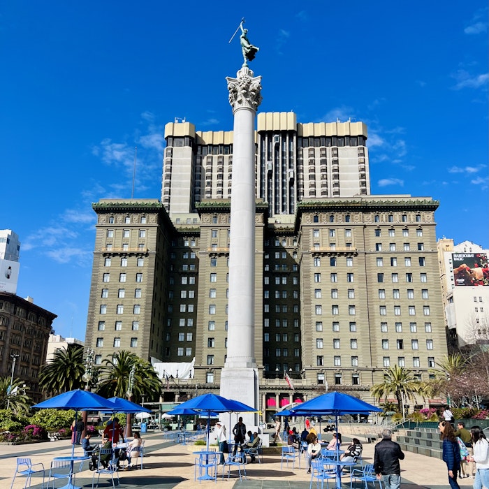 Img: city, urban, downtown, office building, metropolis, shoe, person, handbag, clock tower, high rise