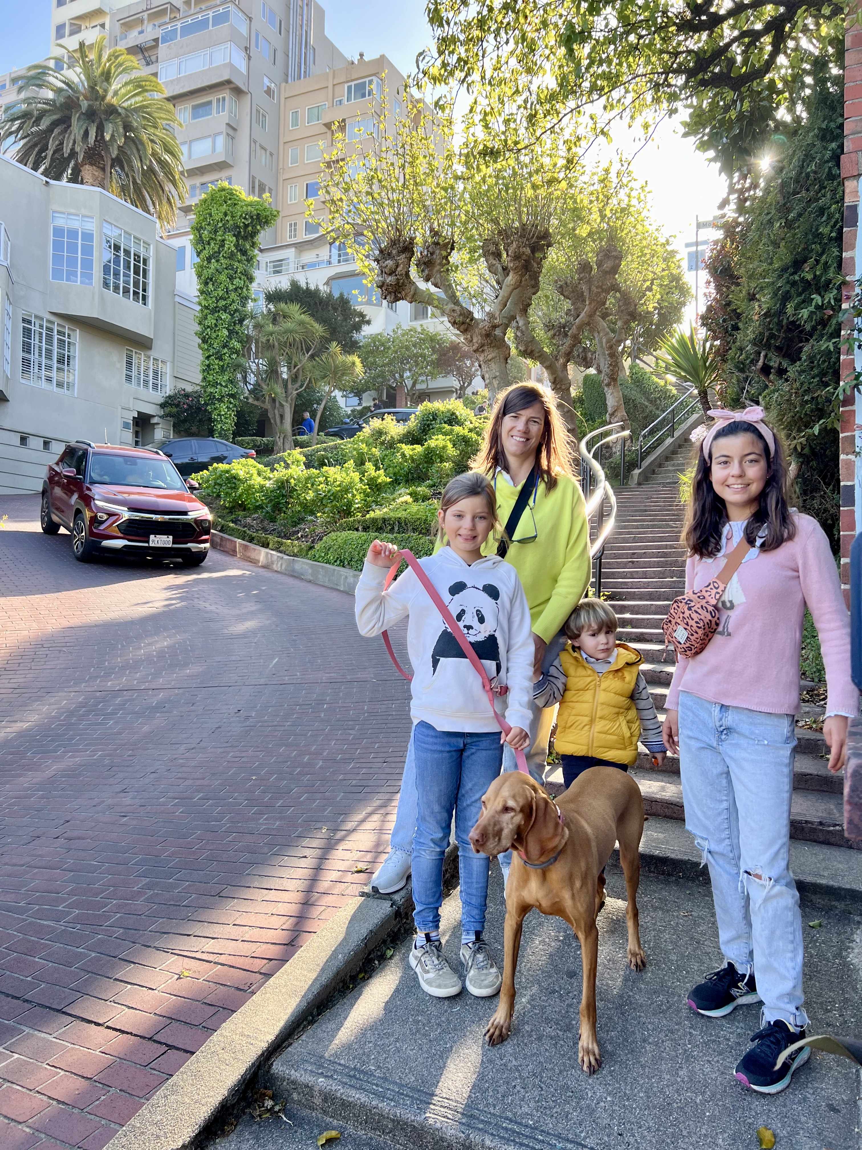 Img: pants, city, female, girl, person, teen, street, neighborhood, people, walking
