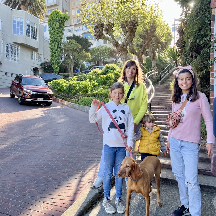 Img: pants, city, female, girl, person, teen, street, neighborhood, people, walking