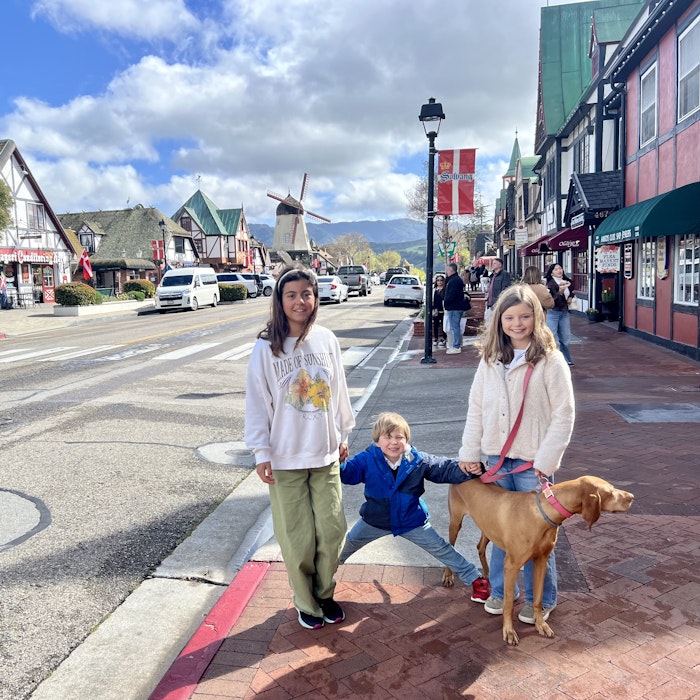 Img: neighborhood, city, road, street, urban, path, shelter, sidewalk, pants, portrait