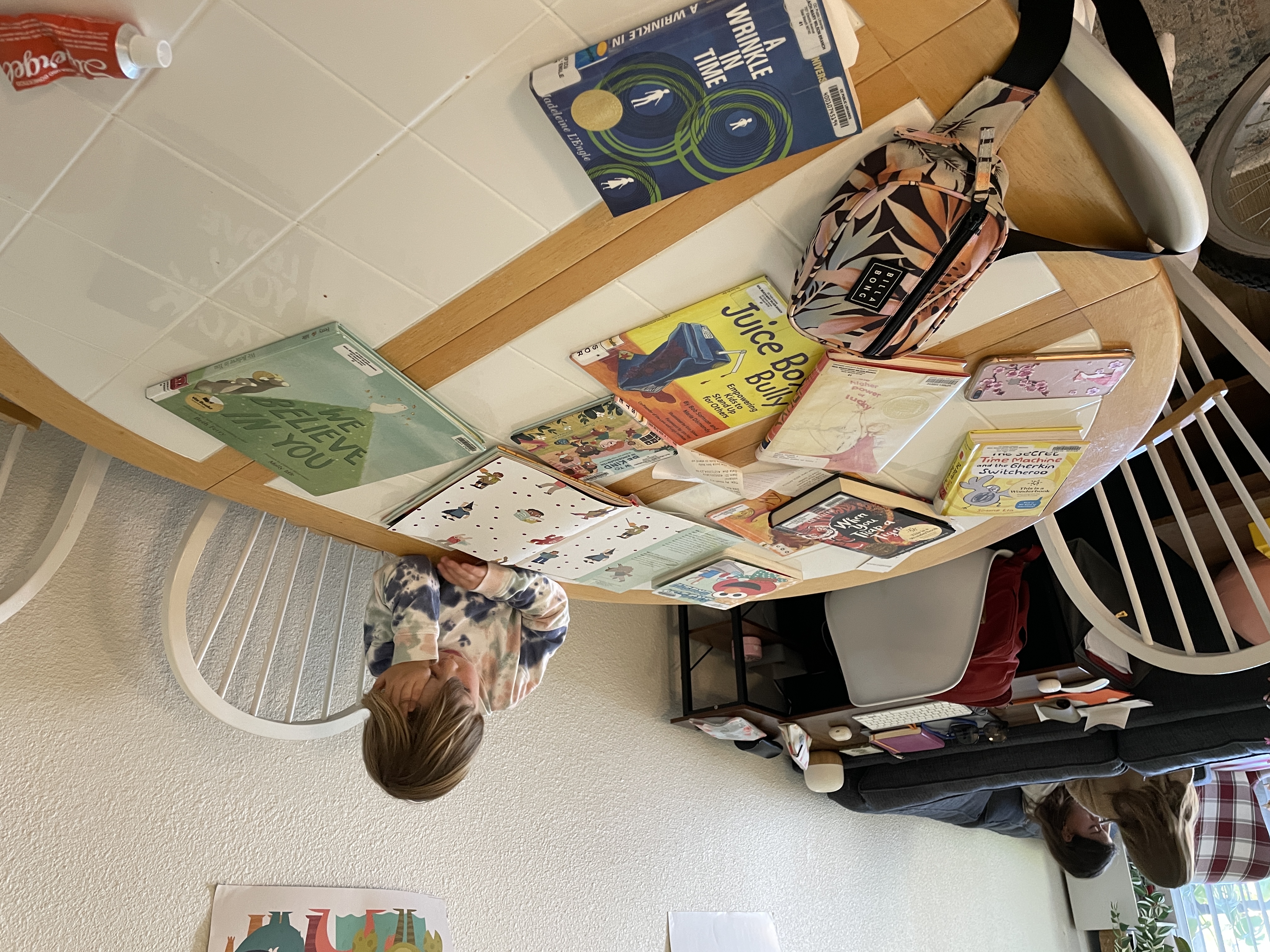 Img: book, furniture, table, desk, tabletop, person, computer keyboard, text, chair, wheel