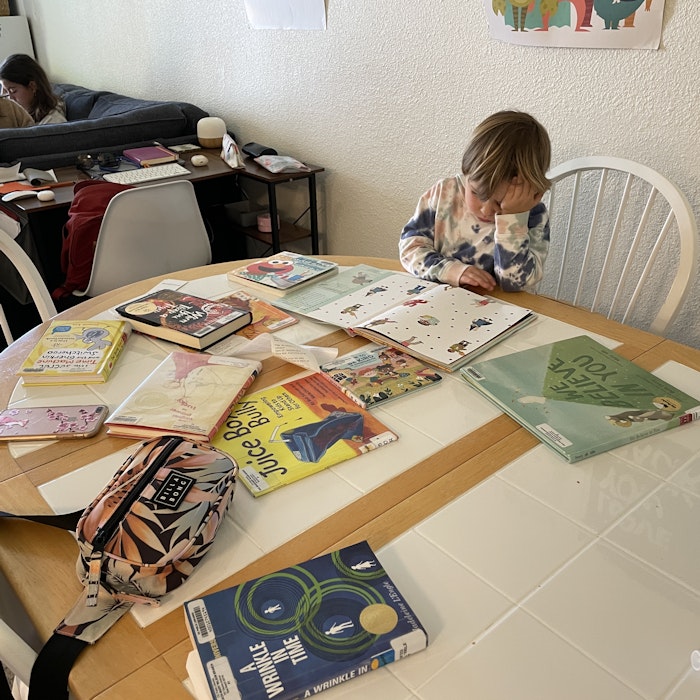 Img: book, furniture, table, desk, tabletop, person, computer keyboard, text, chair, wheel