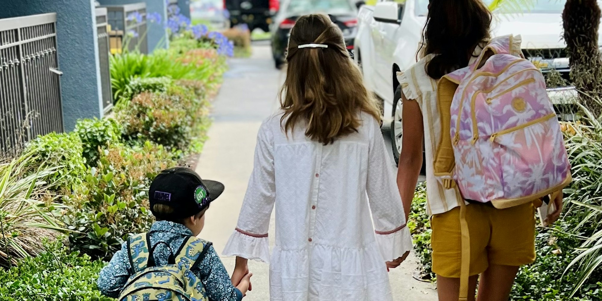 Img: person, walking, child, female, girl, pedestrian, bag, shorts, shoe, city