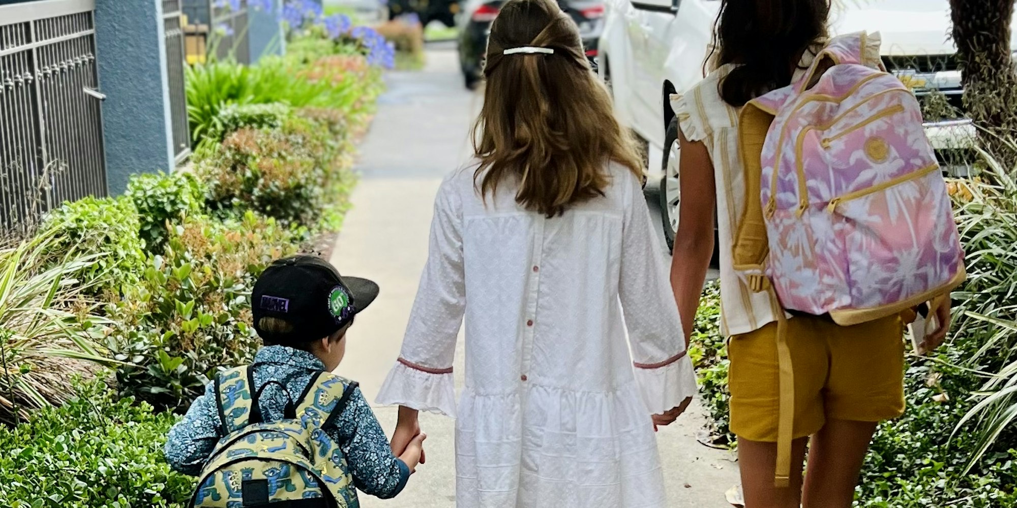 Img: person, walking, child, female, girl, pedestrian, bag, shorts, shoe, city