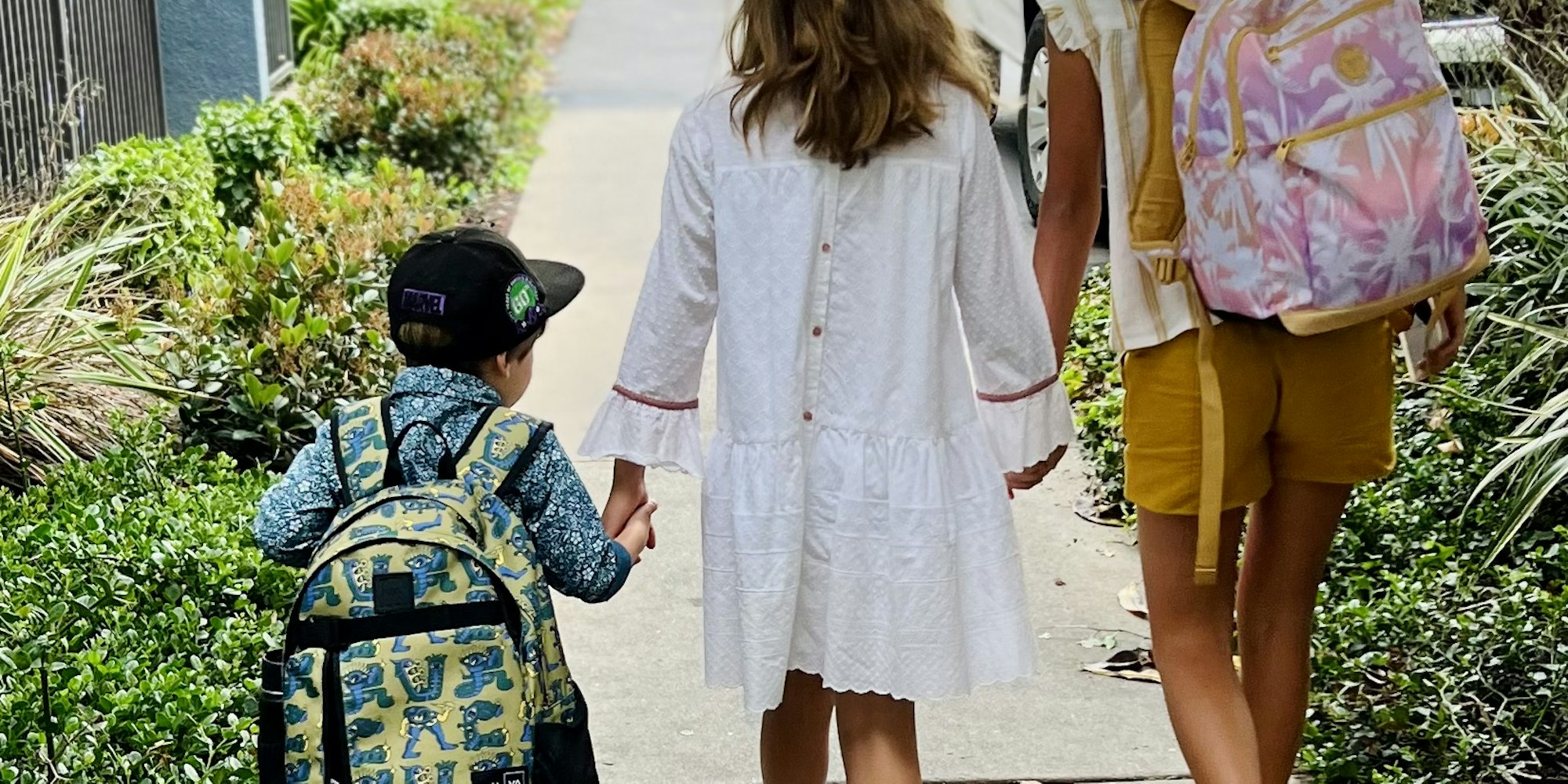 Img: person, walking, child, female, girl, pedestrian, bag, shorts, shoe, city